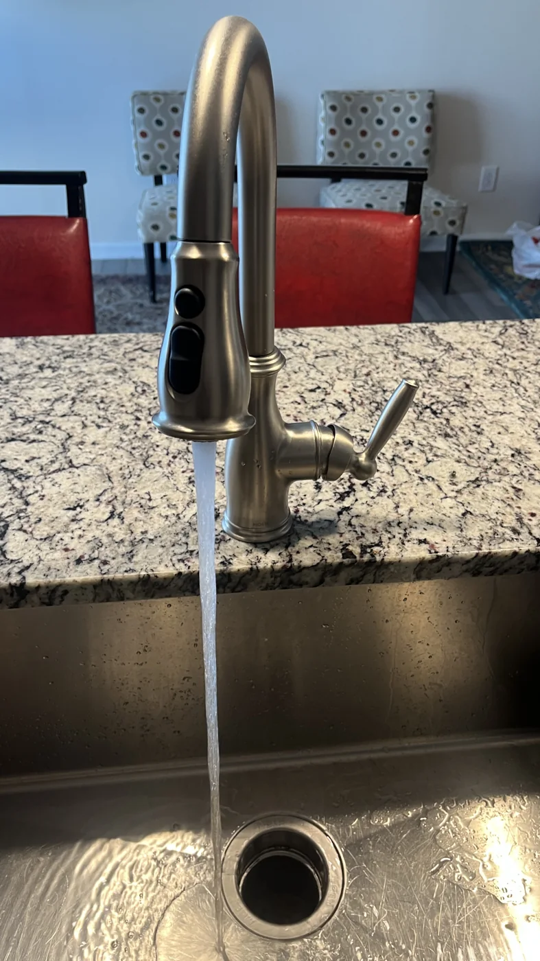 Kitchen faucet above a countertop and sink